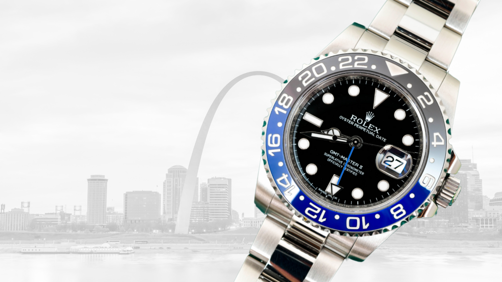 Rolex GMT-Master II watch with a black and blue bezel displayed prominently against the St. Louis skyline featuring the Gateway Arch