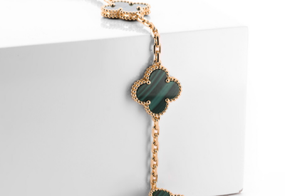 Van Cleef & Arpels Alhambra bracelet featuring green malachite clover motifs and gold detailing, ideal for those selling Van Cleef jewelry in St. Louis