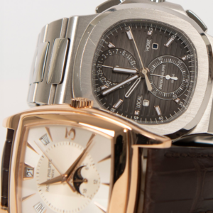 Close-up of two Patek Philippe watches, featuring a stainless steel Nautilus and a rose gold timepiece with a moonphase complication, showcasing luxury craftsmanship.